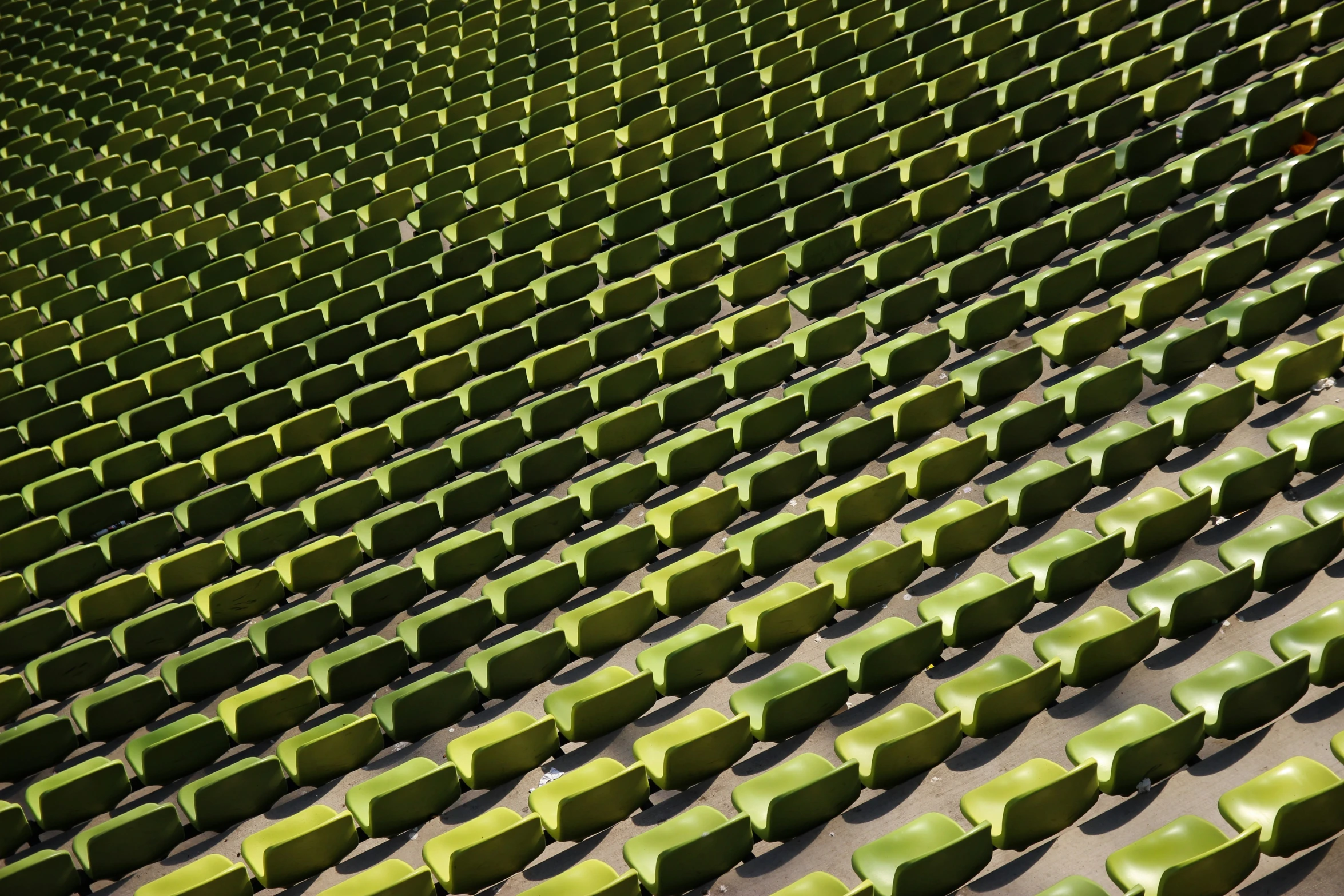 rows of green seats that is very close to each other