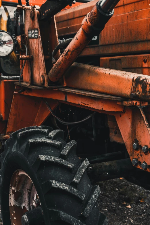 an old tractor sits abandoned on the ground