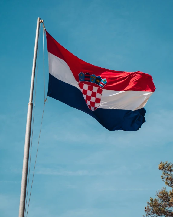 the flag is flying on top of a flag pole