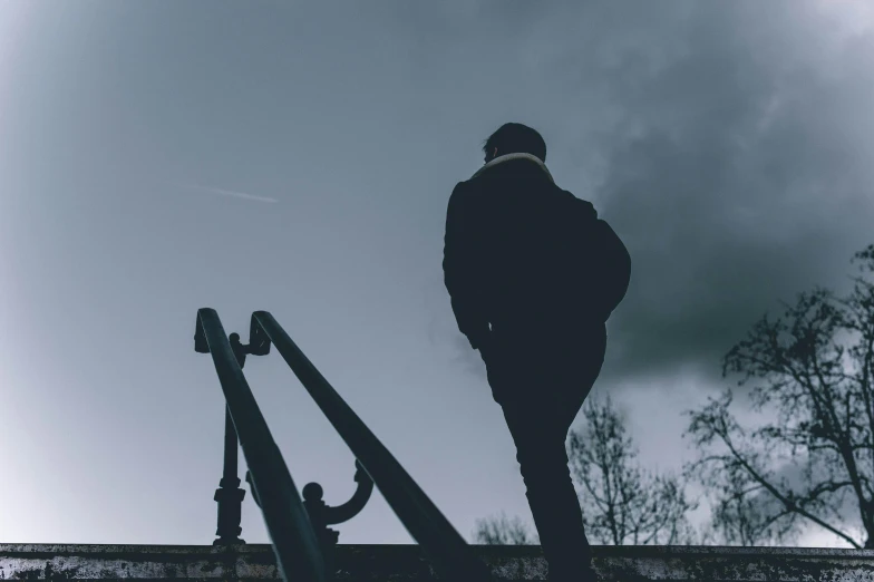 silhouette of a person walking on a walkway