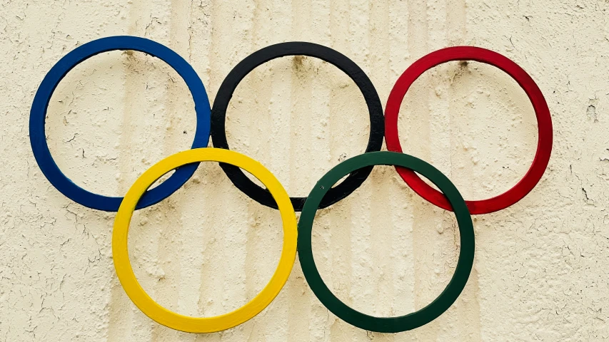 three olympic rings sitting on the wall behind each other