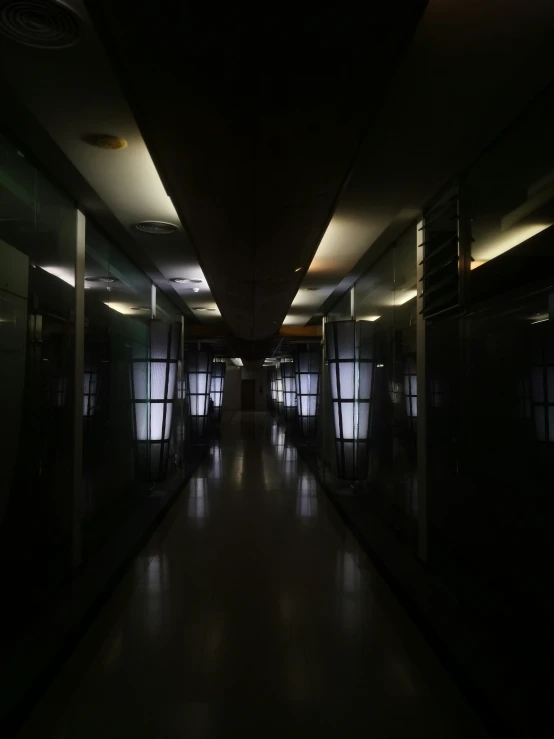 long dark hallway leading to various elevators