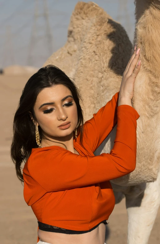 a close up of a person near a camel