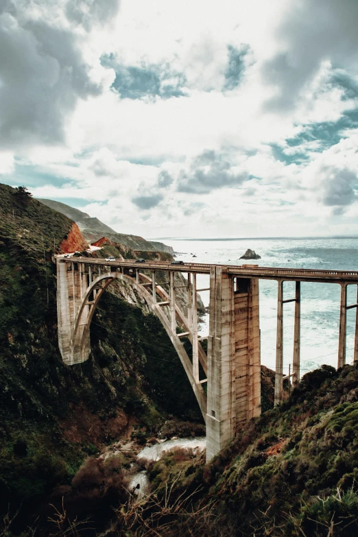 a tall bridge crosses over a large body of water