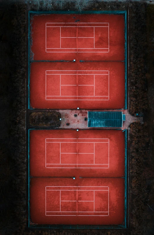 the tennis court is next to an empty box