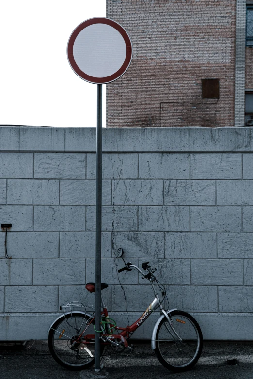 the bicycle is  to the sign post