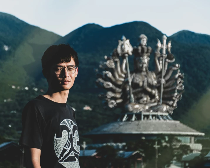 a man standing in front of a large metal structure