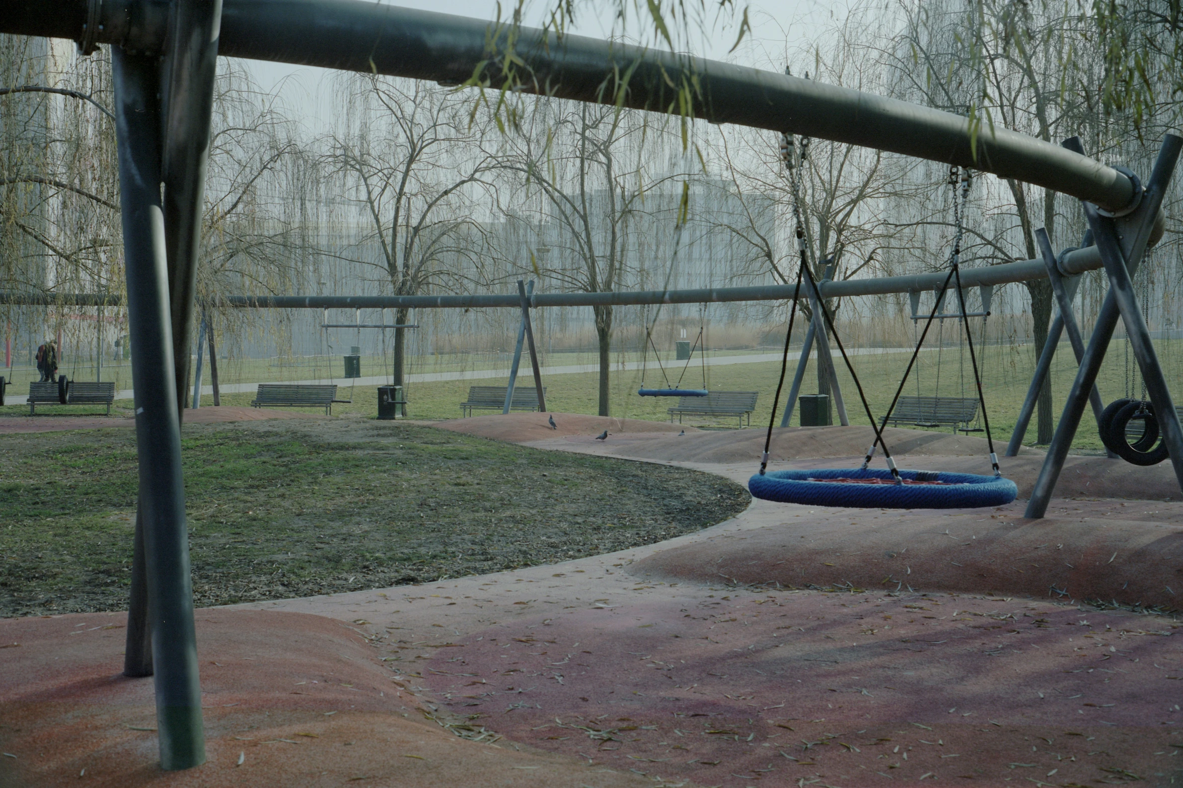 a blue tire swing set in a park