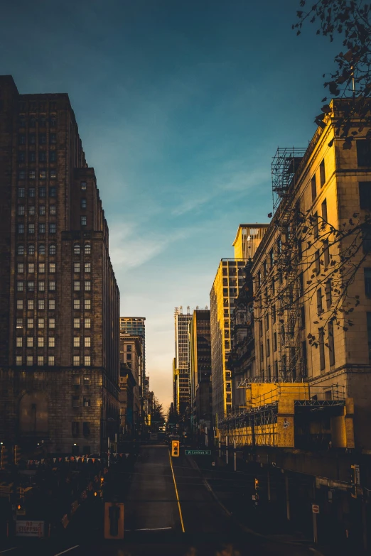 a city street filled with tall buildings and surrounded by scaffolding