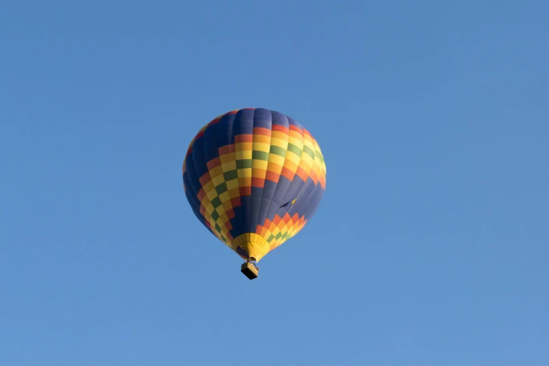 a large balloon in the sky with it's landing gear down