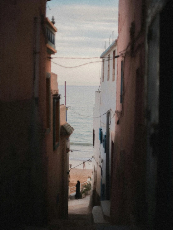 a view looking up at the water from a street with buildings