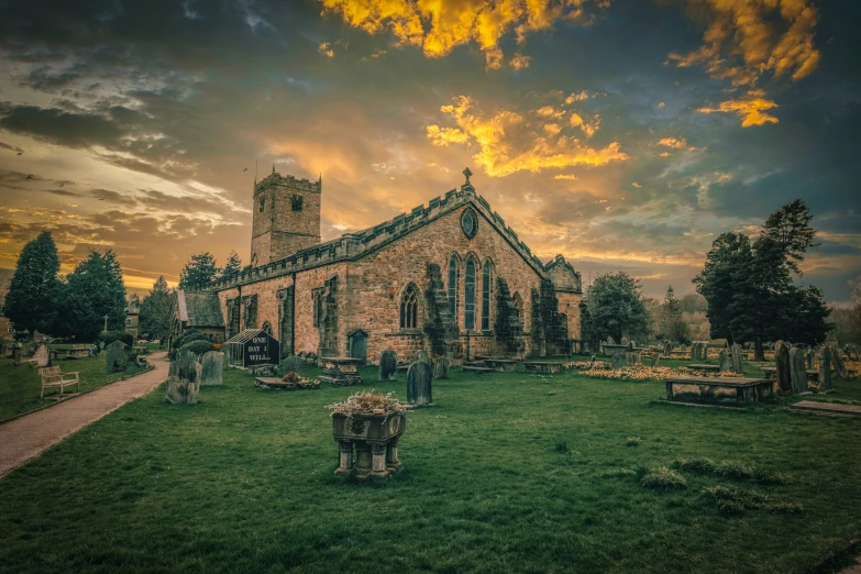 the view of a large old church on green grass