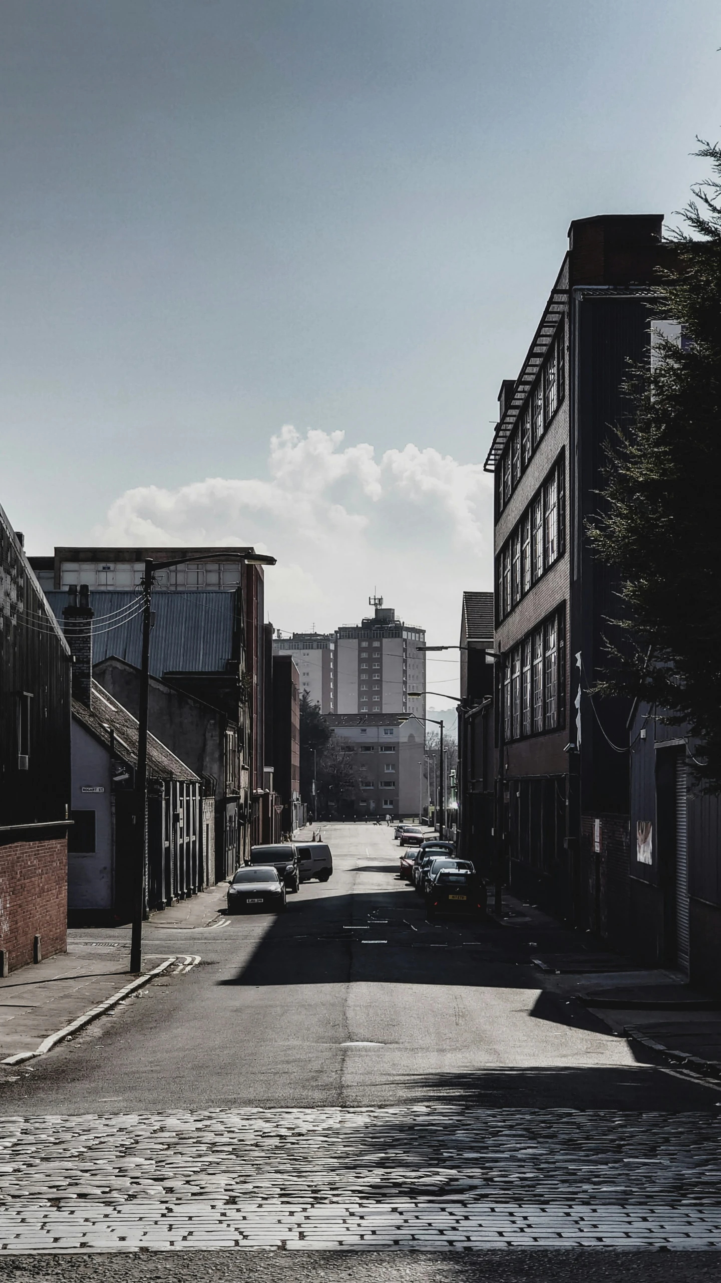 a narrow urban street with no traffic in the daytime