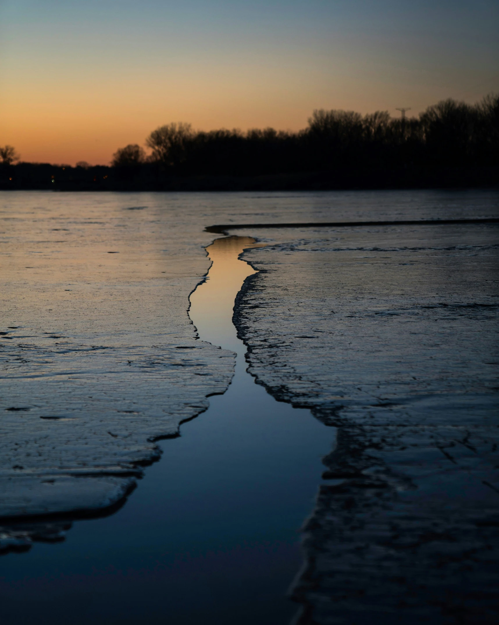 an image of sunset at the edge of a body of water