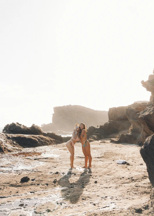 a person standing on some rocks by the water