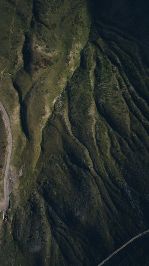 a road in the distance with the top of some hills