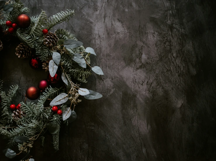 a wreath is displayed with other ornaments on a table