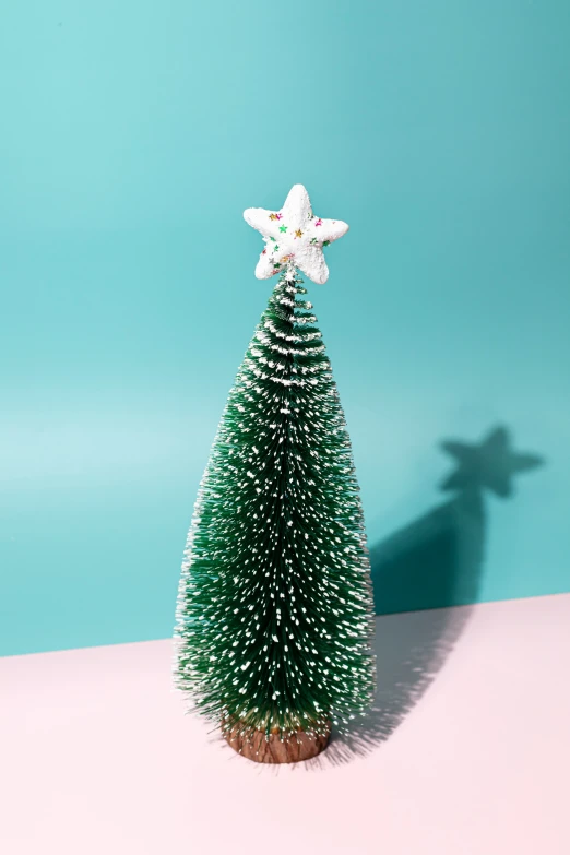 a plastic star and snow flake on top of a small tree