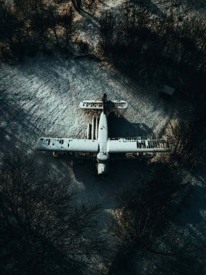 an aerial view of a plane parked in the middle of grass