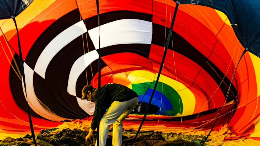 a person at the end of a colorful  air balloon