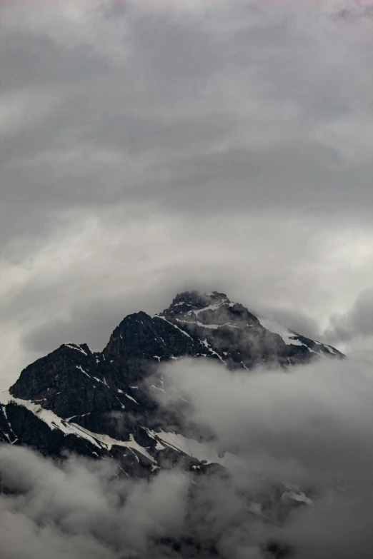 the snowy mountains are covered in fog and light