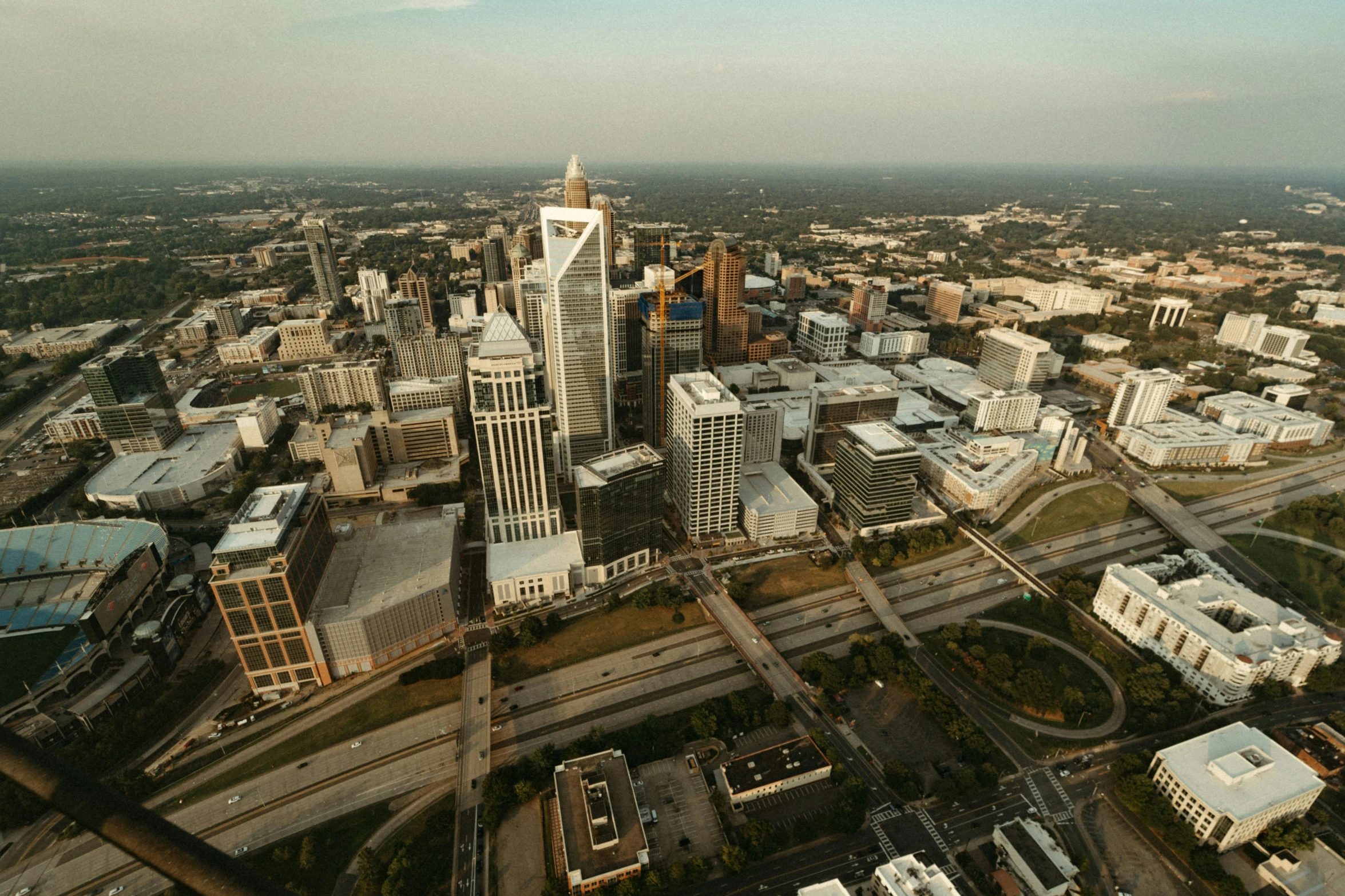 an aerial view of two large buildings in the center of a city