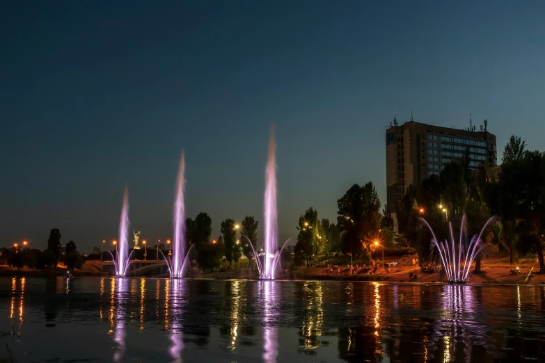 a lake with fountains of water in the middle