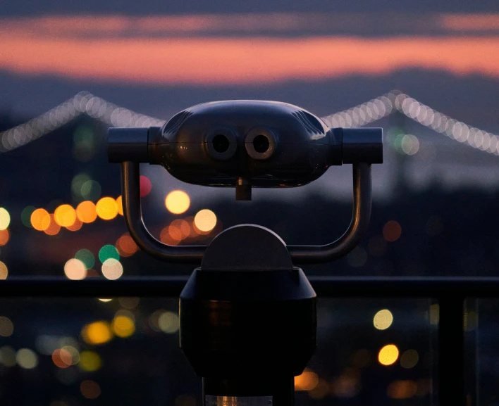 a traffic light overlooking a cityscape at night