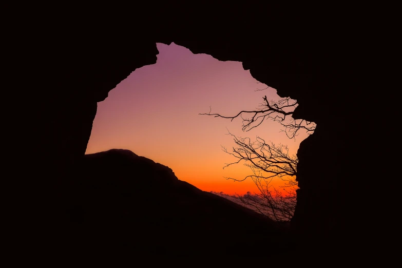 the silhouette of the mountain with a beautiful sunset in the background