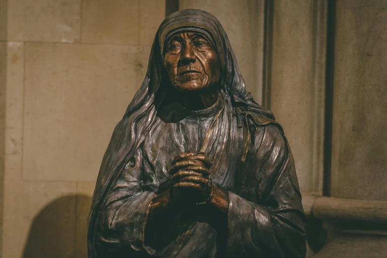 a close - up s of a bronze statue of a nun