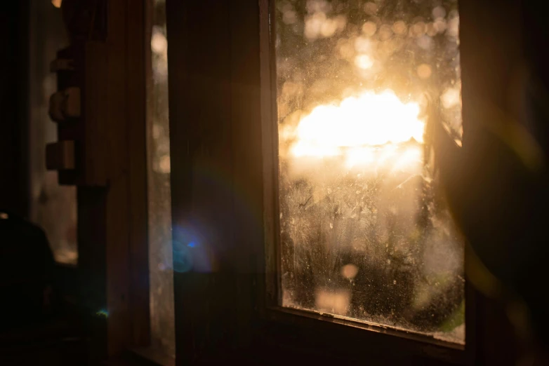 the sun is shining through the window on a rainy day