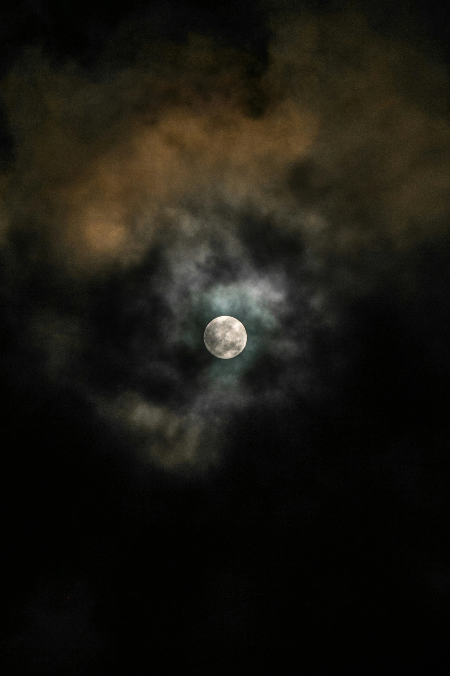 a cloudy night with the moon visible behind it