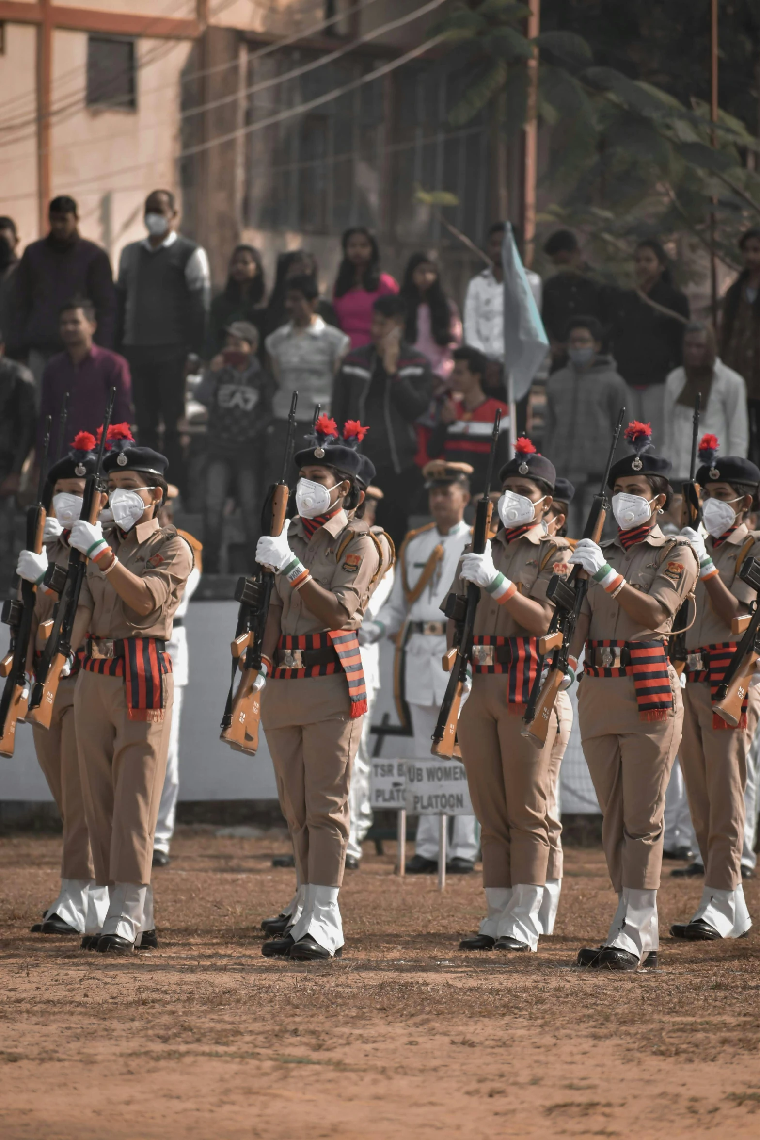 a group of uniformed soldiers stand with their instruments