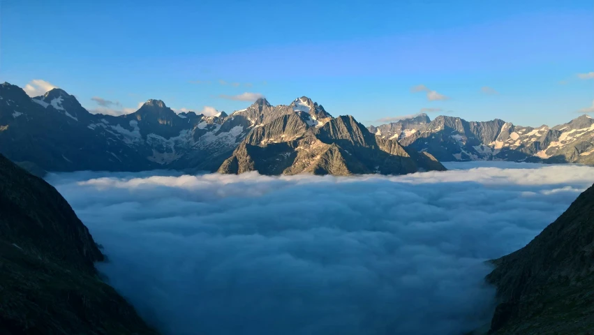 view of mountains, hills and clouds in the distance