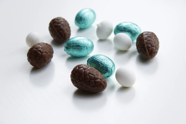 a group of chocolates on white table and blue