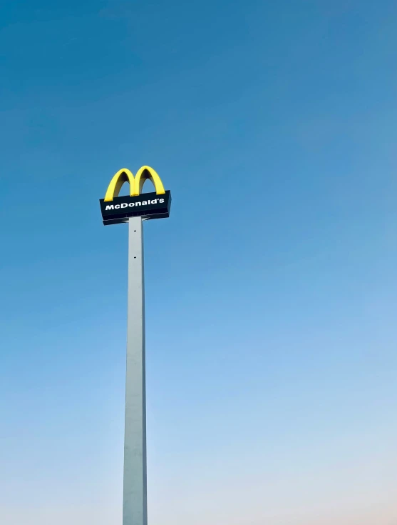 a very tall metal pole with a large sign on it