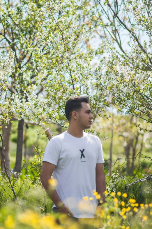 a man is standing in a wooded area looking up