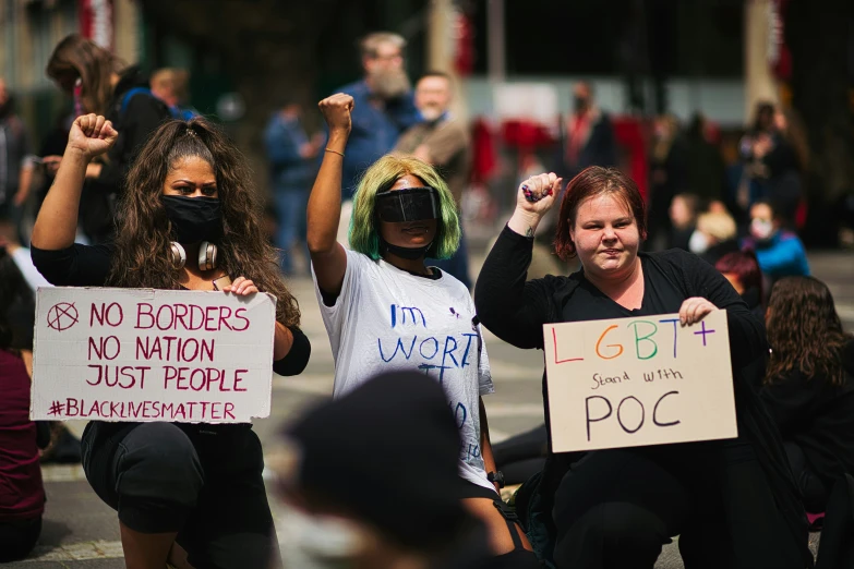 protestors holding signs are pictured in an event