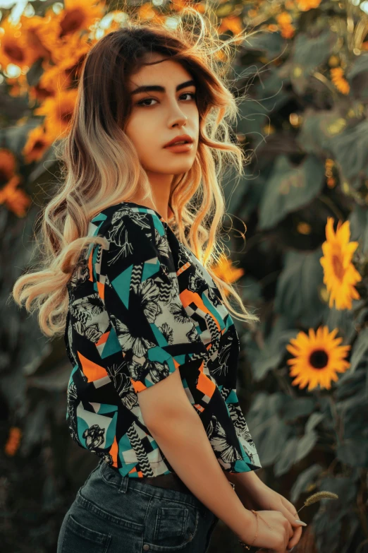 a girl with her hair down wearing a patterned blouse and black jeans