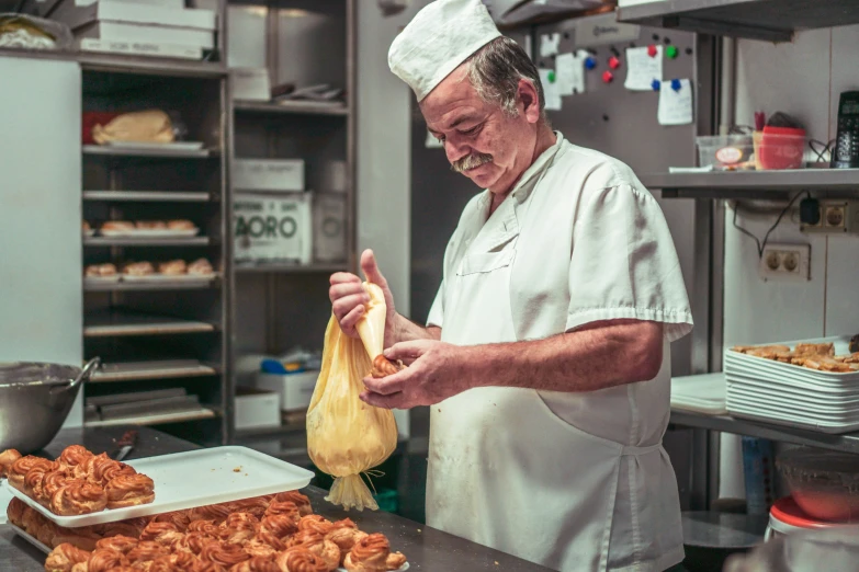 a chef in the kitchen with his bag of fried chicken