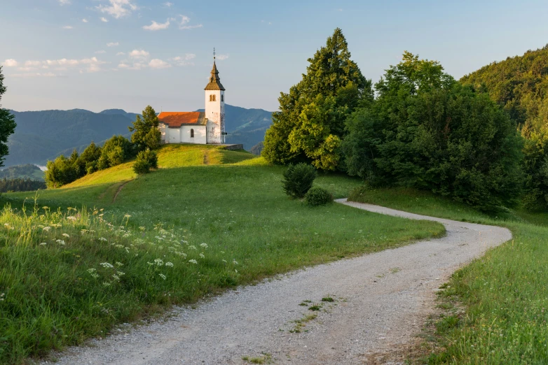 a church is at the top of a hill on top of a hill