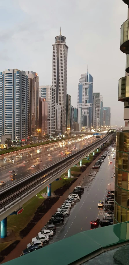 the city skyline is lit up as vehicles drive down the road