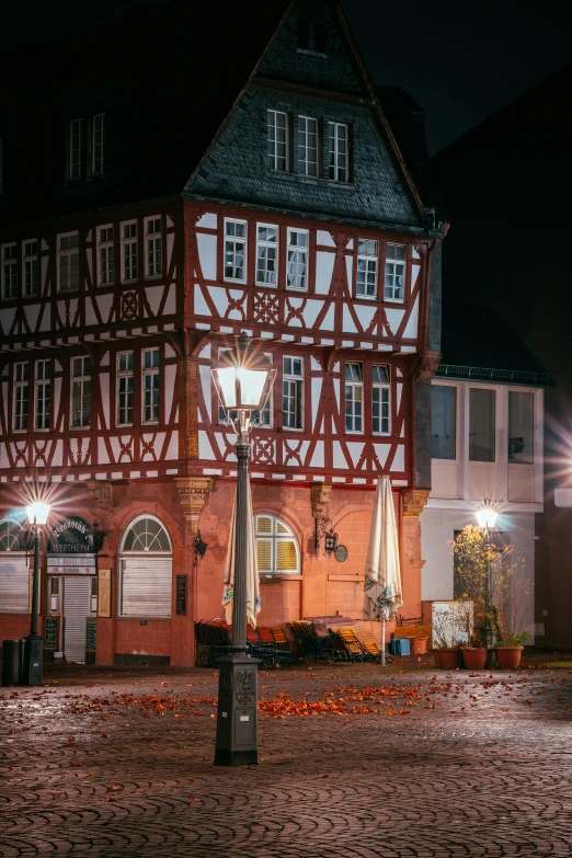 an old building with three balconies on top of it at night