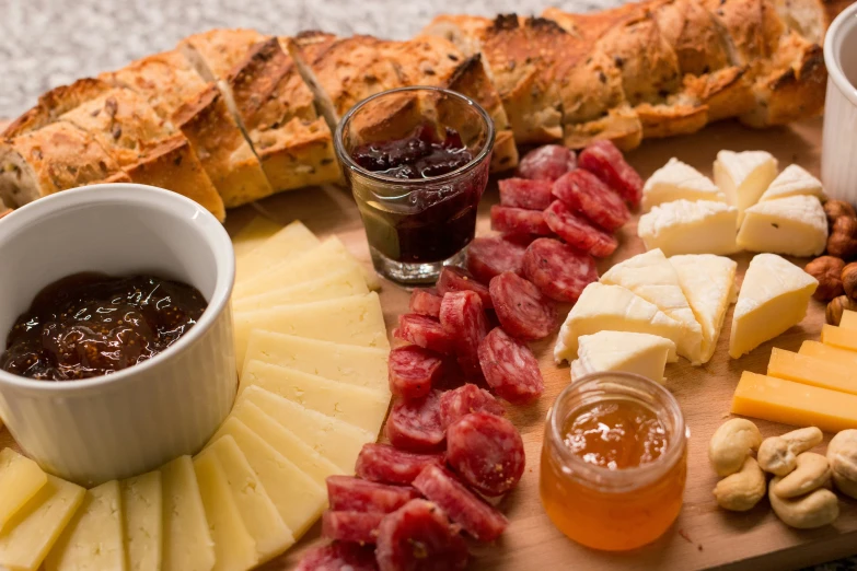 a wooden  board topped with meat and cheese