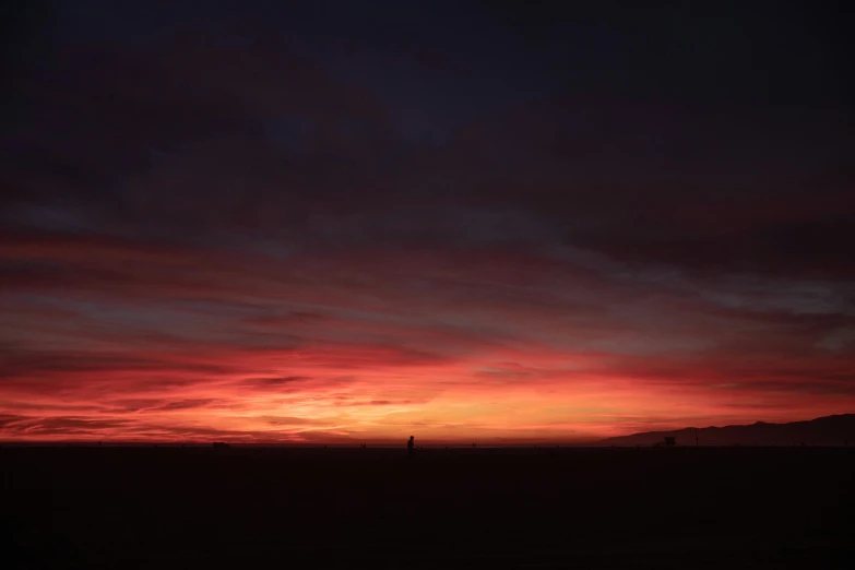 the sky and clouds above the mountains at sunset