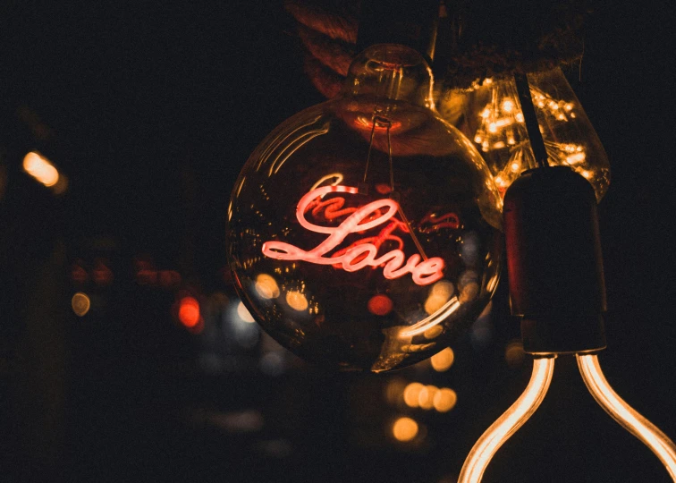 a love balloon hanging on the side of a light pole