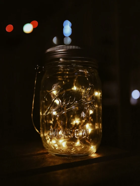 a jar with string lights sits on a table