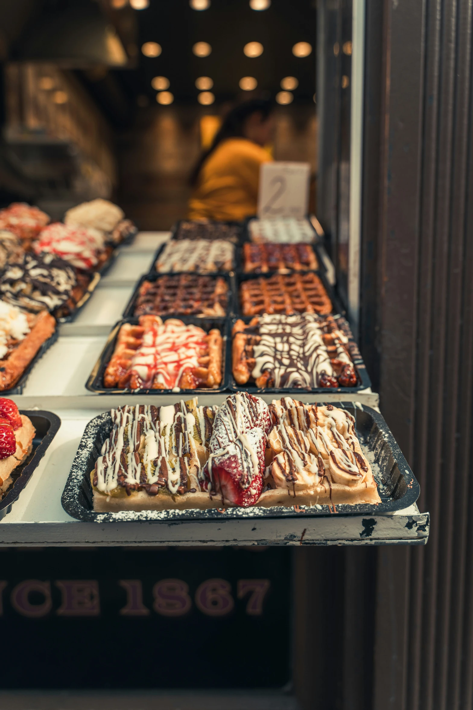 the donuts and waffles are displayed for sale