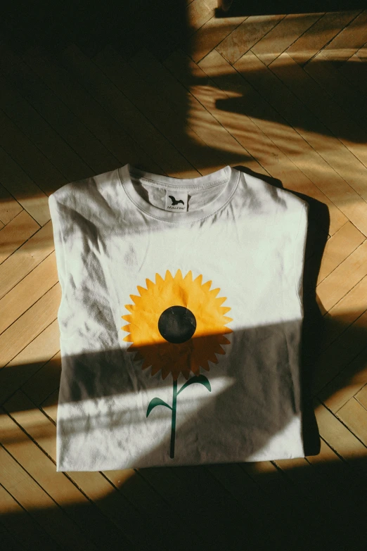 a t - shirt with a sunflower painted on it