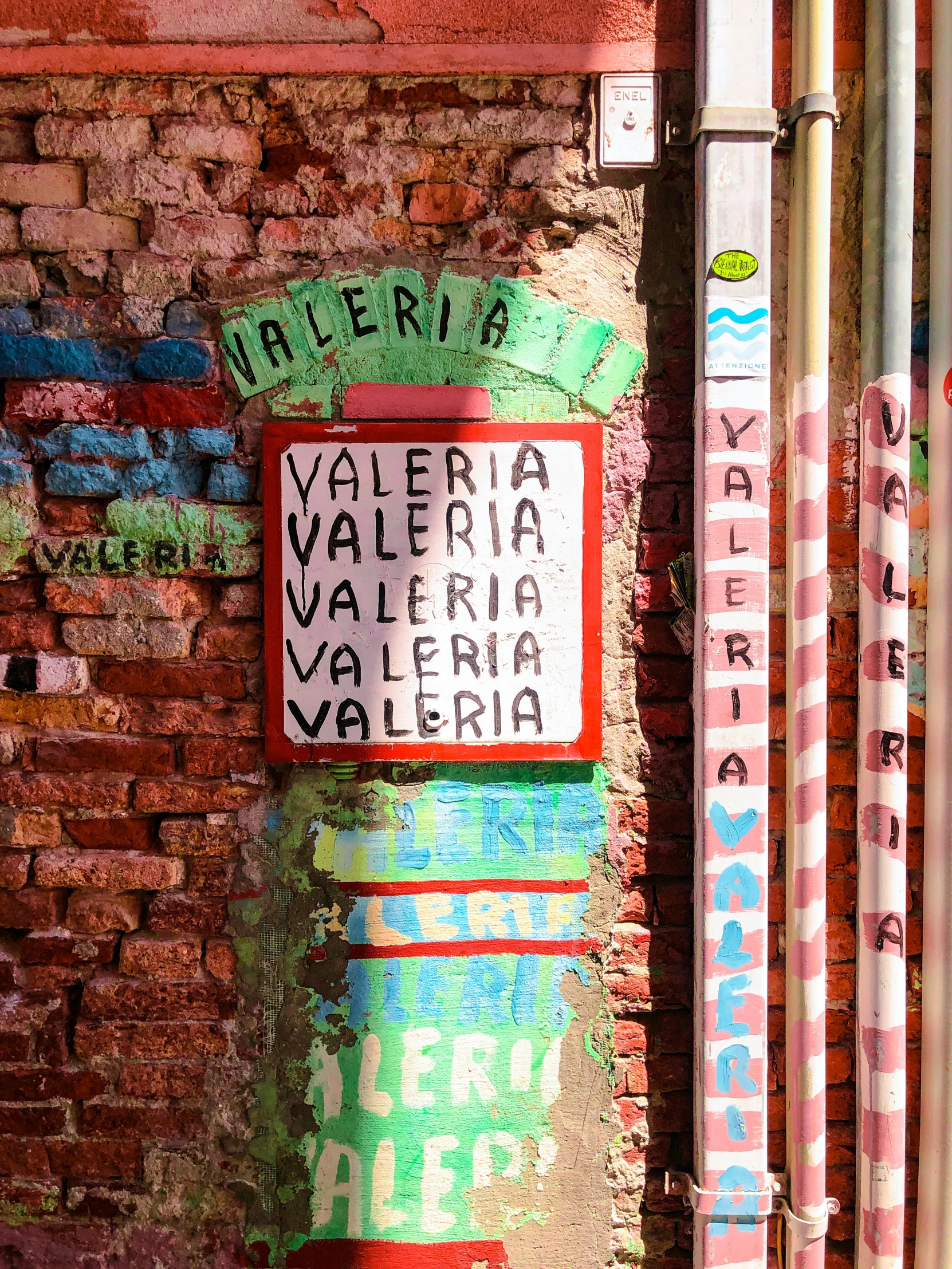 a brick wall with street signs painted on it